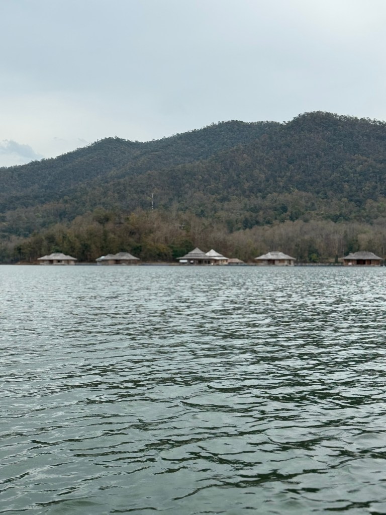 View of Mae Ngat Dam in Sri Lanna National Park with floating bungalows and forested hills in Chiang Mai, Thailand
