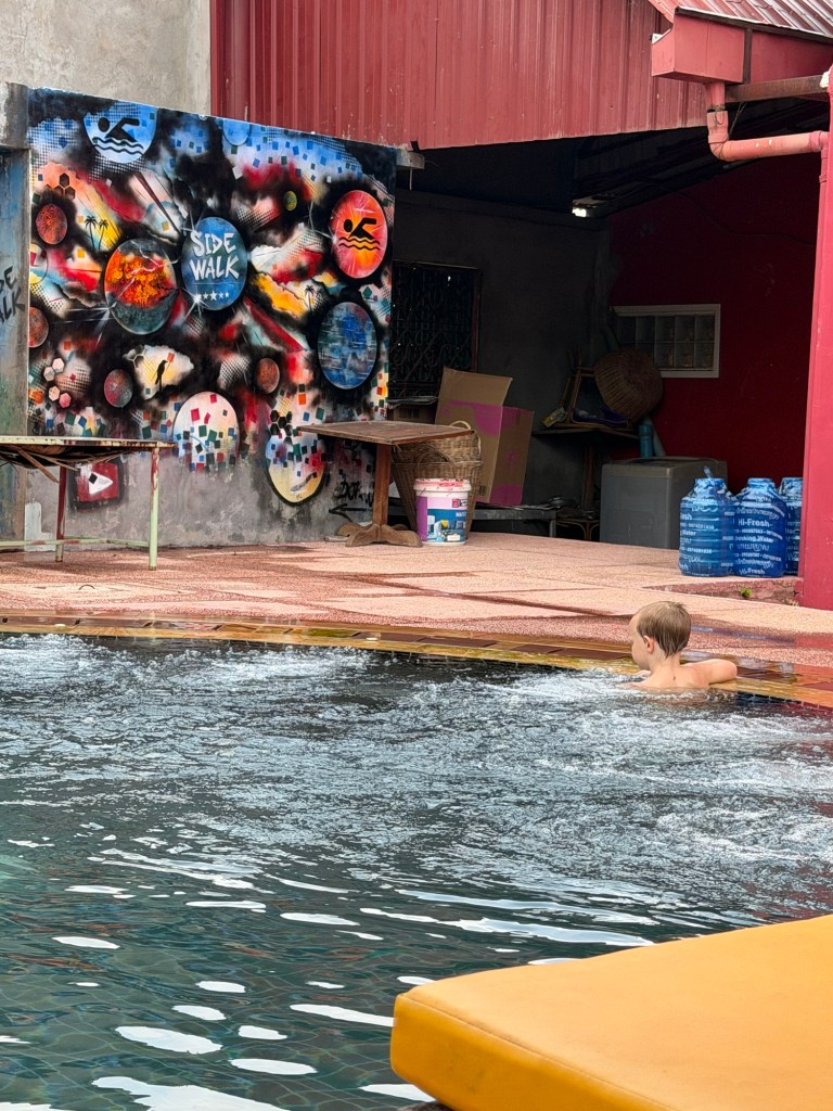 Child swimming in hotel pool in Siem Reap Cambodia during a relaxing afternoon
