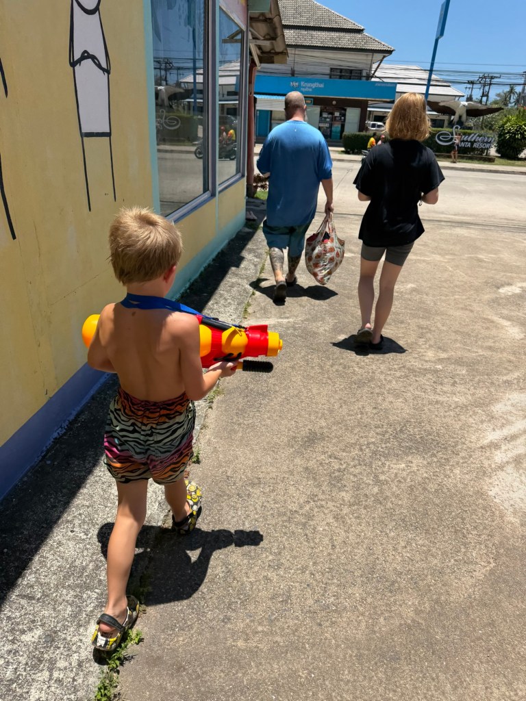Young boy carrying a water gun during Songkran celebrations in Koh Lanta, Thailand.