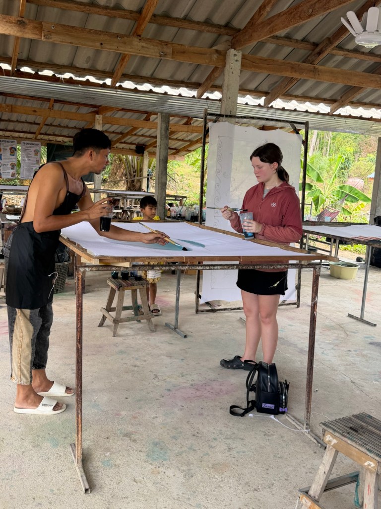 Teen girl participating in a batik art class at Lanta Batik in Koh Lanta, Thailand.